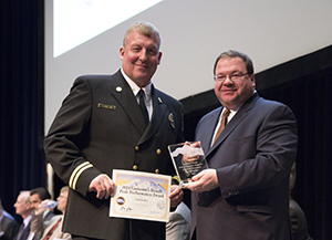 Photo of Todd Kollar receiving Exceptional Performance award